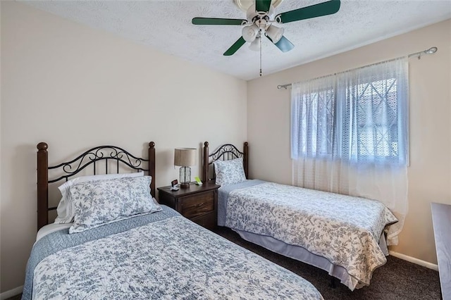 carpeted bedroom featuring ceiling fan and a textured ceiling