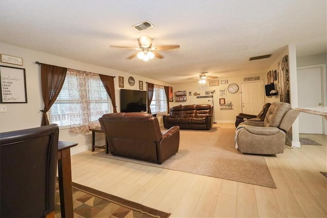 living room featuring hardwood / wood-style flooring and ceiling fan