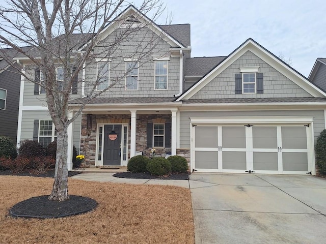 view of front facade with a garage and covered porch