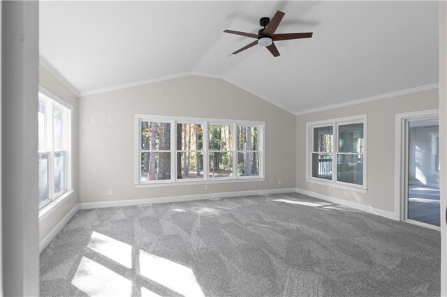 unfurnished living room with ceiling fan, light colored carpet, ornamental molding, and vaulted ceiling