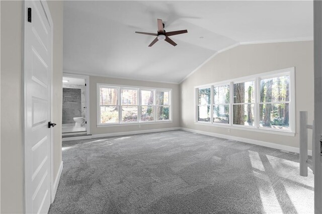 unfurnished living room with ornamental molding, carpet floors, ceiling fan, and lofted ceiling