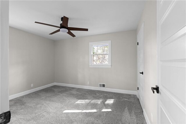 empty room featuring carpet flooring and ceiling fan