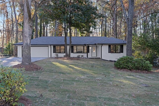 ranch-style home featuring a front yard and a garage