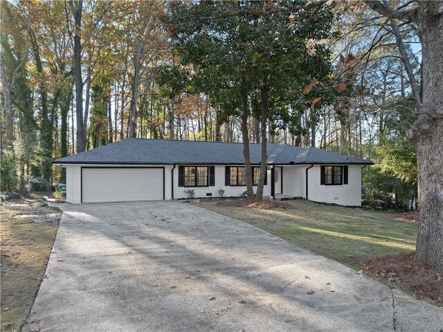 single story home featuring a garage and a front lawn