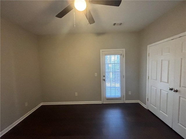 interior space with ceiling fan and dark wood-type flooring