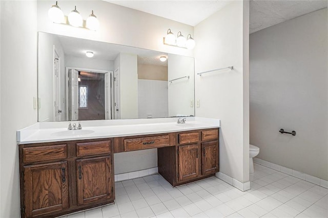 bathroom featuring toilet, vanity, and tile patterned floors