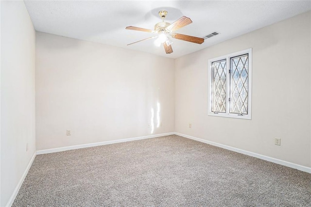 spare room featuring ceiling fan and carpet flooring