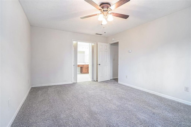 spare room featuring ceiling fan and carpet