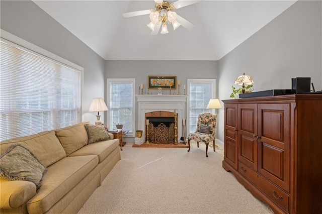 living room featuring light carpet, high vaulted ceiling, ceiling fan, and a fireplace