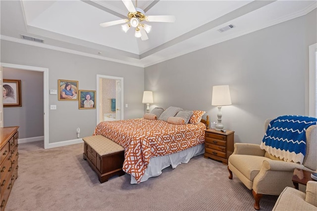 bedroom featuring a tray ceiling, light colored carpet, visible vents, and baseboards