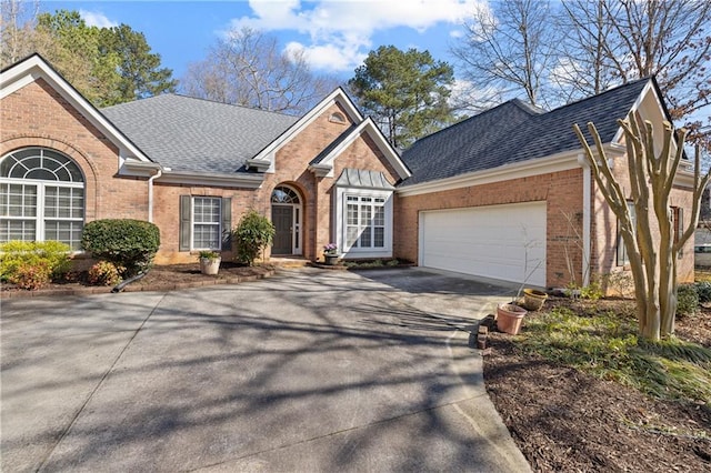 single story home featuring brick siding, concrete driveway, a shingled roof, and a garage