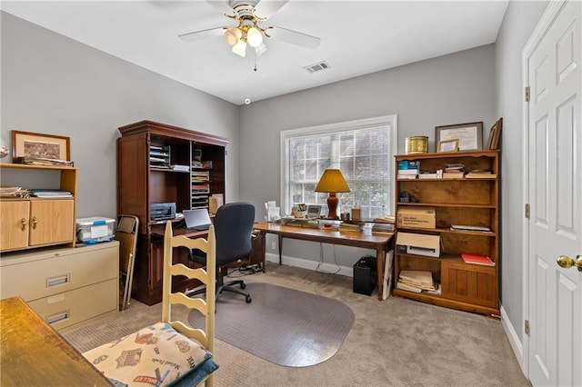 home office featuring light carpet, visible vents, baseboards, and ceiling fan