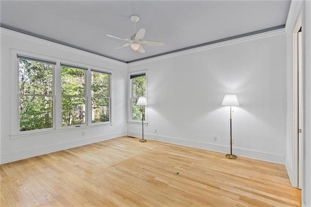 spare room featuring light hardwood / wood-style floors, plenty of natural light, crown molding, and ceiling fan