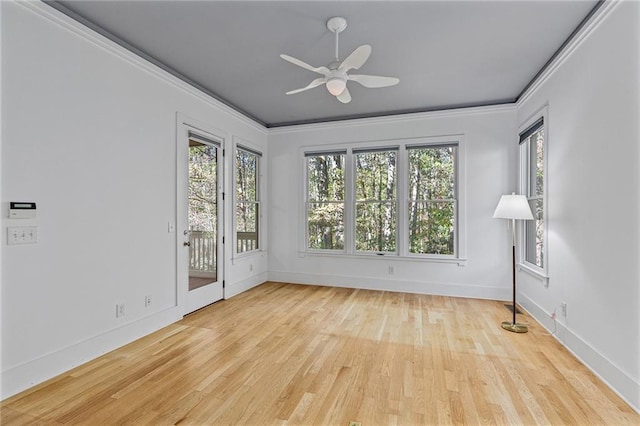 spare room with crown molding, light hardwood / wood-style flooring, and ceiling fan