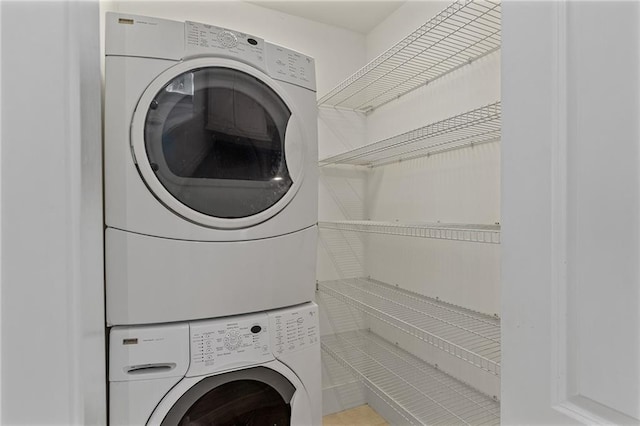 clothes washing area featuring stacked washer / dryer