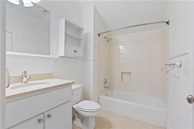 full bathroom with tile patterned floors, tiled shower / bath combo, toilet, and vanity