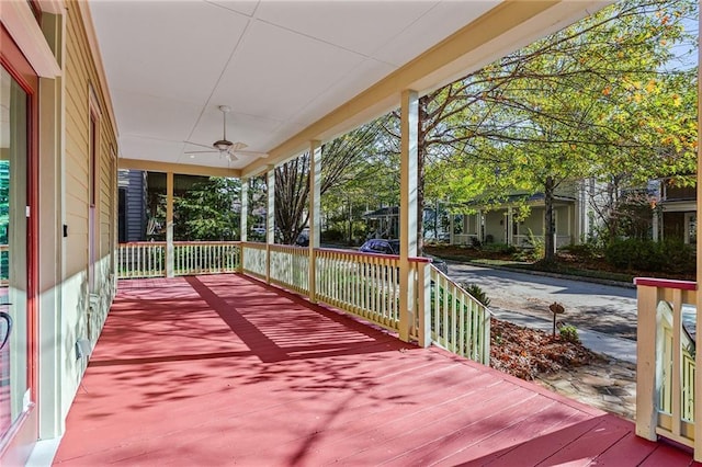 wooden deck featuring covered porch and ceiling fan