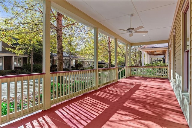 deck with ceiling fan and a porch