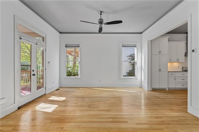 interior space featuring french doors, light wood-type flooring, ceiling fan, and ornamental molding