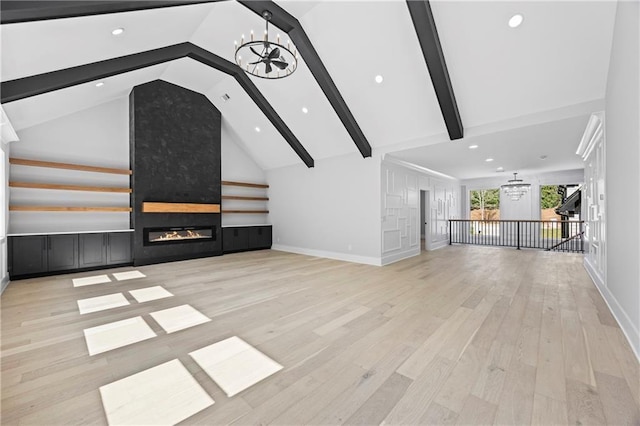 6238 Mount Salem Cir, Flowery Branch, GA 30542 - unfurnished living room featuring a chandelier, beam ceiling, a large fireplace, wood finished floors, and recessed lighting