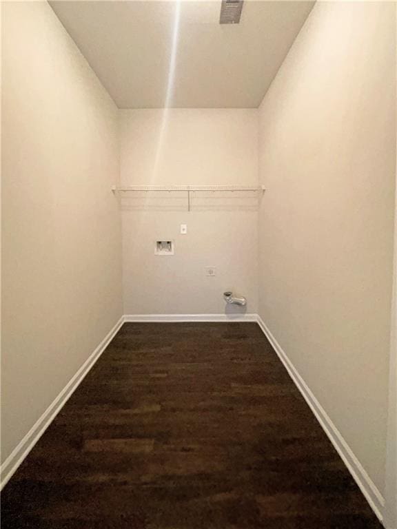 washroom featuring baseboards, dark wood-type flooring, hookup for a washing machine, and laundry area