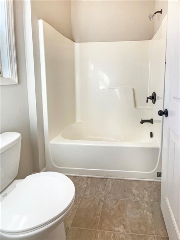 full bath with toilet, tile patterned flooring, and shower / tub combination