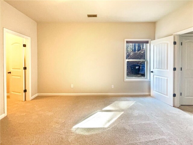 unfurnished bedroom featuring visible vents, carpet floors, and baseboards
