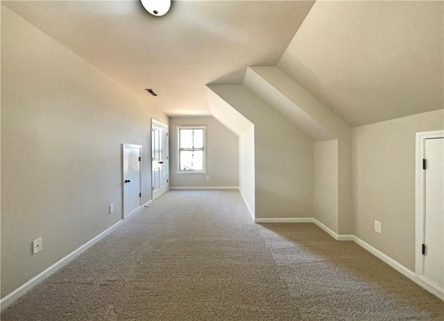 bonus room featuring lofted ceiling, carpet flooring, and baseboards