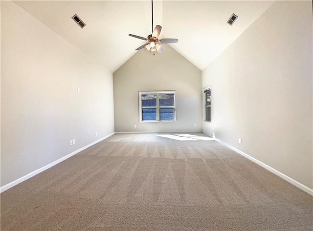 spare room with baseboards, a ceiling fan, visible vents, and high vaulted ceiling