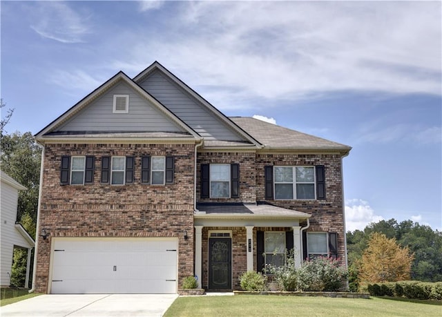 view of front of property with a front yard and a garage