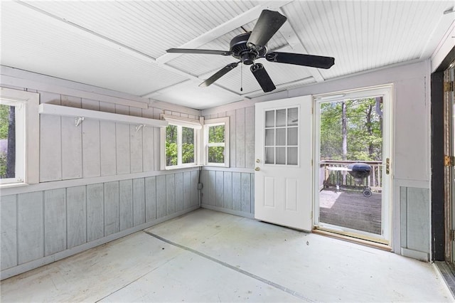 unfurnished sunroom with ceiling fan