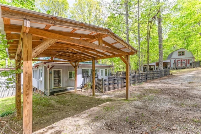 view of patio / terrace featuring fence and an outbuilding