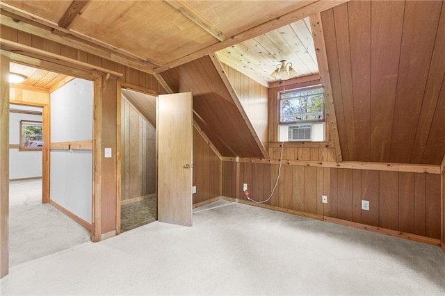 additional living space featuring wooden ceiling, wooden walls, and carpet flooring