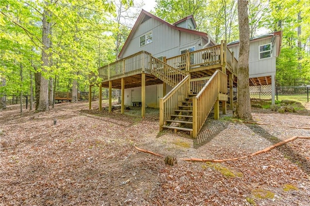 back of property with fence, stairway, and a wooden deck