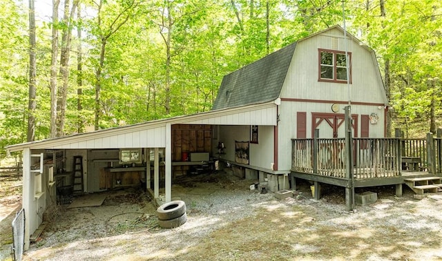 view of outdoor structure featuring an outbuilding and a view of trees