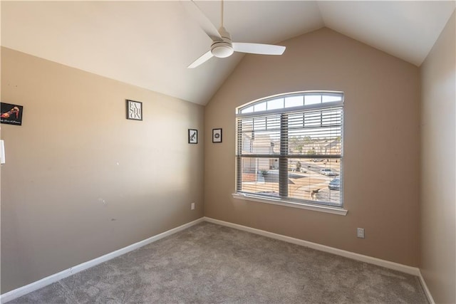 carpeted empty room featuring vaulted ceiling and ceiling fan