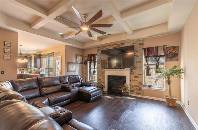 living room featuring a healthy amount of sunlight, coffered ceiling, and dark wood-type flooring