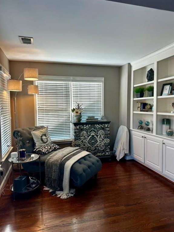 living area with dark wood-type flooring and built in shelves