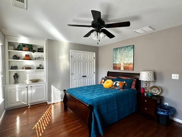 bedroom featuring dark wood-type flooring, ceiling fan, and a closet