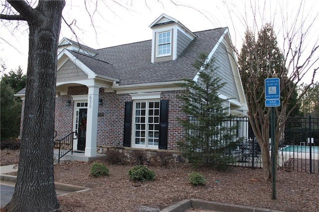 view of front of home with a fenced in pool