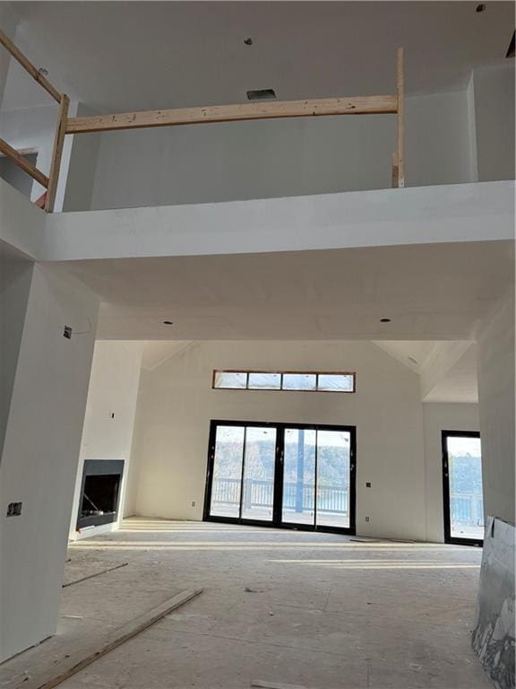 unfurnished room featuring a high ceiling