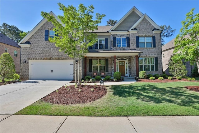 13015 Fox Rd, Alpharetta, GA 30005 - craftsman-style home with covered porch, brick siding, an attached garage, and a front lawn