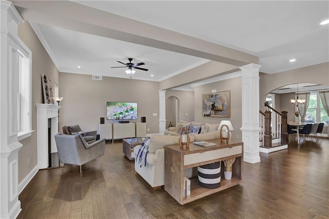 13015 Fox Rd, Alpharetta, GA 30005 - living area featuring ornate columns, arched walkways, ceiling fan, a fireplace, and dark wood-type flooring