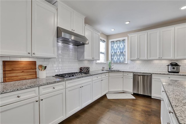 13015 Fox Rd, Alpharetta, GA 30005 - kitchen with appliances with stainless steel finishes, under cabinet range hood, white cabinets, tasteful backsplash, and dark wood finished floors
