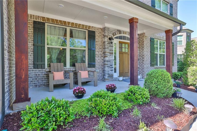 13015 Fox Rd, Alpharetta, GA 30005 - doorway to property featuring covered porch and brick siding