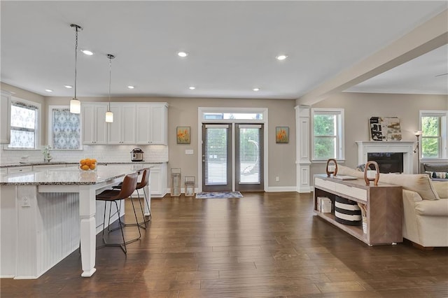 13015 Fox Rd, Alpharetta, GA 30005 - living area with dark wood-style floors, a glass covered fireplace, and recessed lighting