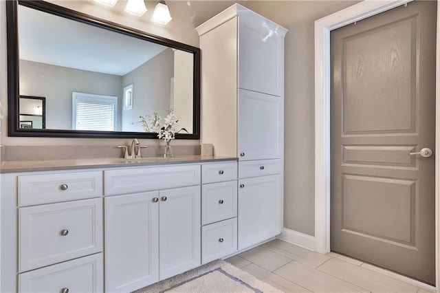 13015 Fox Rd, Alpharetta, GA 30005 - bathroom with vanity and baseboards