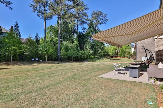 13015 Fox Rd, Alpharetta, GA 30005 - view of grassy yard with an outdoor fire pit and a patio