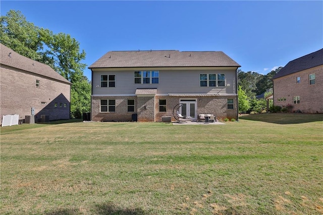 13015 Fox Rd, Alpharetta, GA 30005 - back of property with a patio, brick siding, a yard, and french doors
