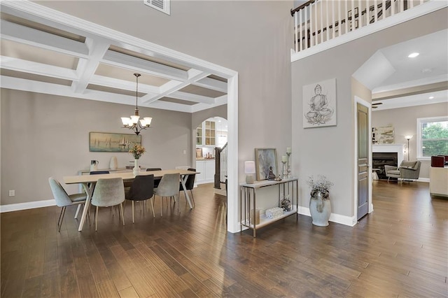 13015 Fox Rd, Alpharetta, GA 30005 - dining area with arched walkways, a fireplace, hardwood / wood-style flooring, coffered ceiling, and beam ceiling